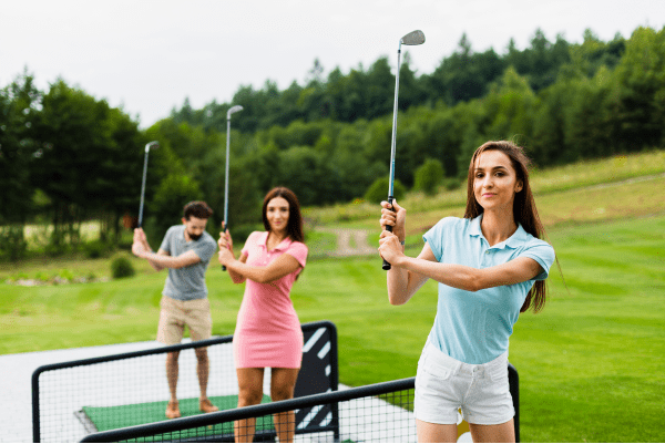 Front view young golfers with stick up